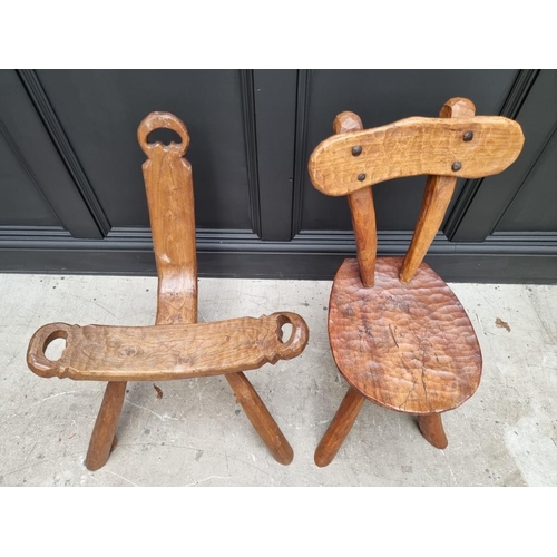 1827 - An elm birthing stool; together with another rustic elm three legged stool. (2)