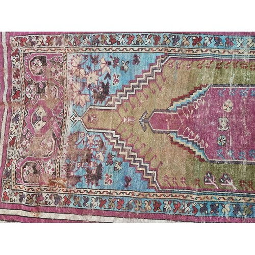 1015 - A Persian rug, having temple design to central field, with floral and geometric borders, 173 x 115cm... 