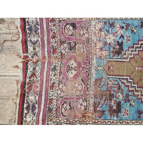 1015 - A Persian rug, having temple design to central field, with floral and geometric borders, 173 x 115cm... 