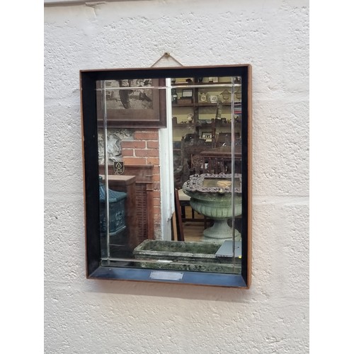 1111 - A mid-century ebonized rectangular wall mirror, 49 x 38.5cm.