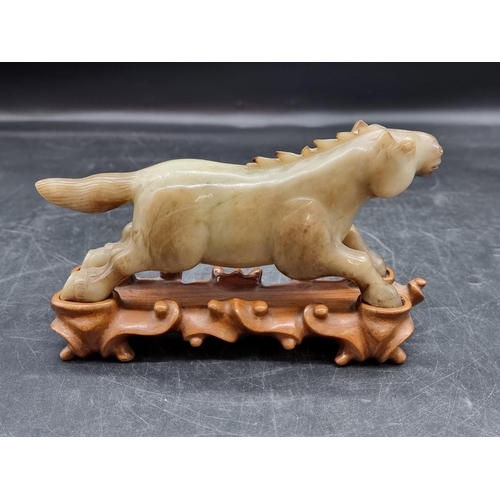 1513 - A Chinese jade horse, 19cm long, on fitted hardwood stand. 