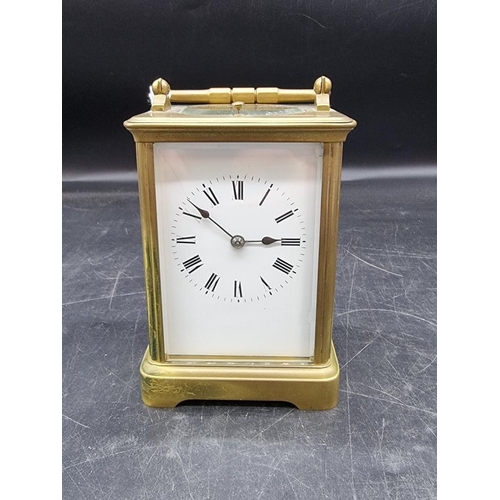 1545 - An antique brass carriage clock, with push button repeat and gong strike, height including handle 18... 