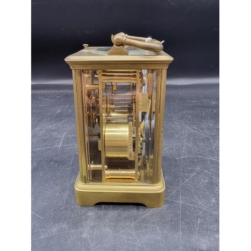 1545 - An antique brass carriage clock, with push button repeat and gong strike, height including handle 18... 