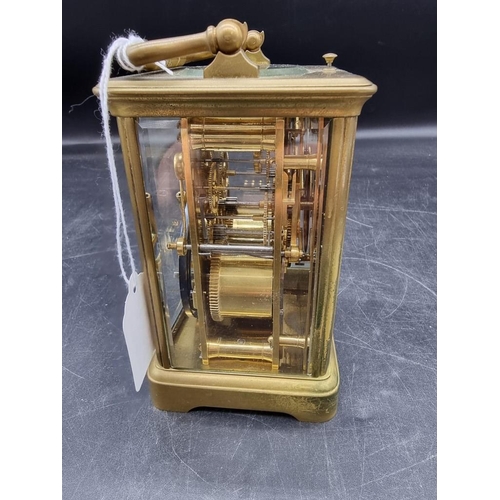 1545 - An antique brass carriage clock, with push button repeat and gong strike, height including handle 18... 