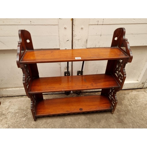 1026 - A late 19th/early 20th century mahogany fretwork hanging three tier shelf, 62cm wide.... 