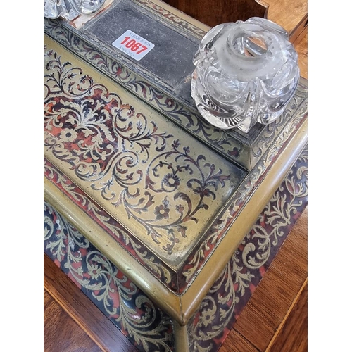 1067 - A 19th century tortoiseshell and brass Boulle desk stand, 37cm wide, (s.d.).