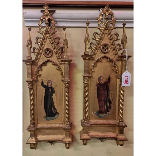 1186 - A pair of carved gilt wood tabernacle framed paintings of saints, 45 x 14cm. (2)