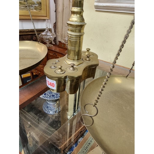 1340 - A large and unusual set of brass balance scales, with weights, 66.5cm high. 