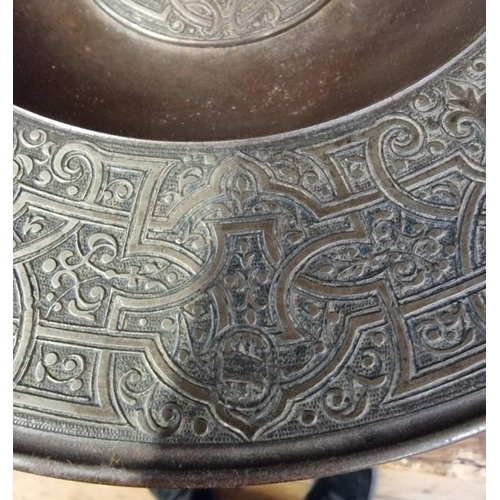 1498 - An unusual 19th century Islamic style iron or steel dish, with stylized decoration, 24.5cm diameter.... 