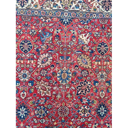 1000 - A Persian carpet, having allover floral decoration to central field, with floral borders, 295 x 200c... 