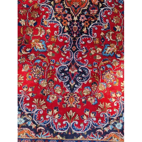 1000A - A Persian carpet, having floral central medallion, with floral cartouches to each corner, 293 x 200c... 