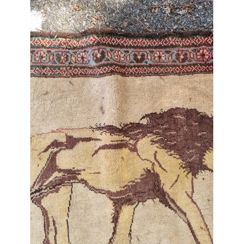 1003 - A lion design rug, with floral borders, 150 x 106cm. 