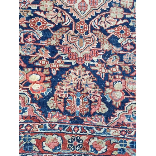 1012 - A Persian rug, having central floral medallion, with floral decoration to each corner, 199 x 131cm.... 