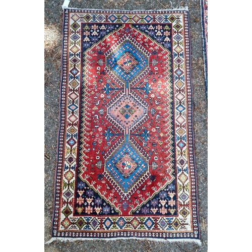 1013 - A small Persian rug, having three central medallions, with floral and geometric borders, 142 x 81cm.... 
