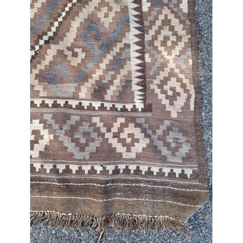 1014 - An Afghan Kelim rug, having two geometric medallions, 407cm x 165cm.
