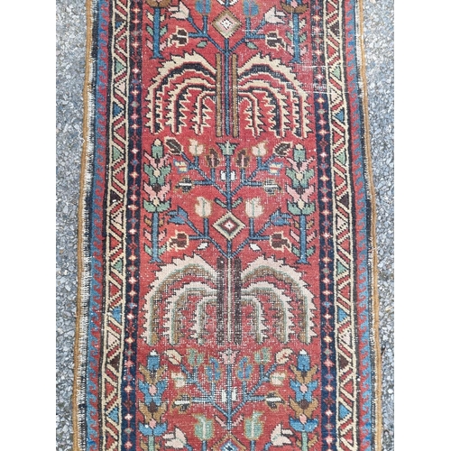 1016 - A Persian runner, having tree design to central field, with geometric borders, 277 x 60cm; together ... 