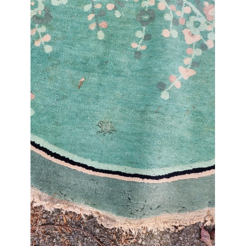 1018 - An antique Chinese oval rug, 220 x 136cm. 