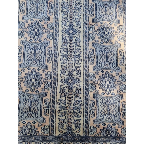 1021 - A Bokhara rug, having repeated design, 192 x 126cm. 