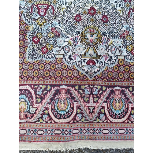 1023 - A part silk Tehran rug, having urn and bird decoration to central field, with floral borders, 1... 
