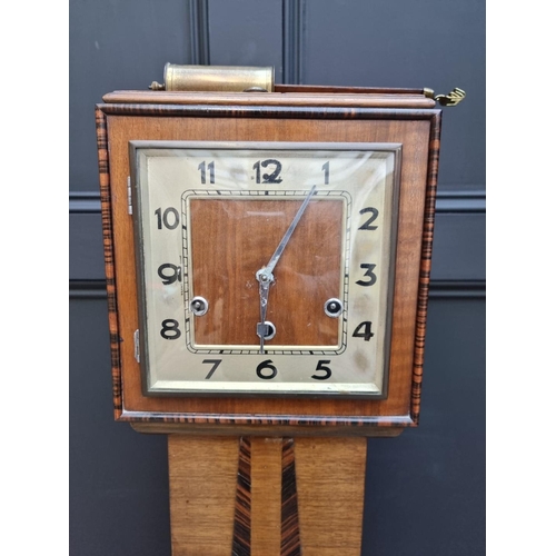 1024 - A 1930s Art Deco walnut and coromandel crossbanded grandmother clock, 139cm high; together with anot... 