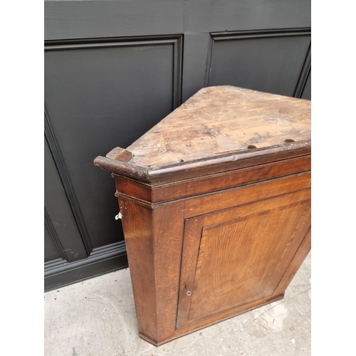 1038 - A George III oak and mahogany crossbanded hanging corner cupboard, 107.5cm high x 92cm wide; togethe... 