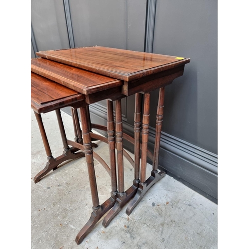 1050 - A nest of three rosewood occasional tables, largest 51.5cm wide. 