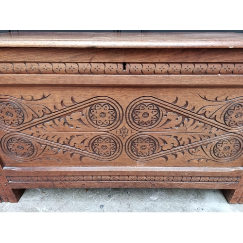 1055 - An antique carved walnut coffer, 97cm wide, 