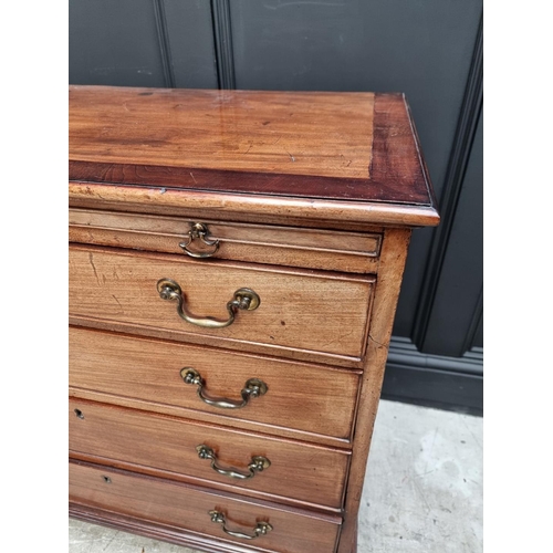 1059 - A small George III mahogany and crossbanded four drawer chest, with brushing slide, 87cm wide.... 