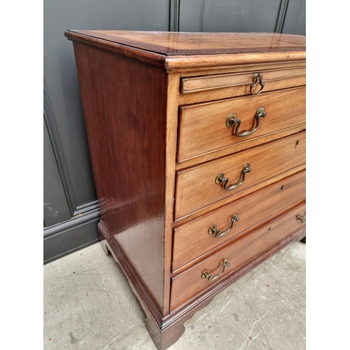 1059 - A small George III mahogany and crossbanded four drawer chest, with brushing slide, 87cm wide.... 