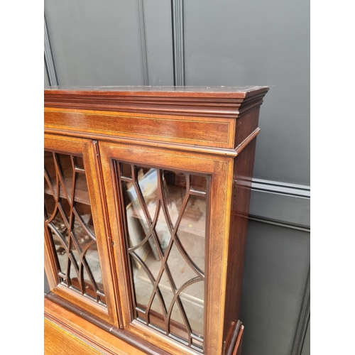 1062 - A small Edwardian mahogany and inlaid bureau bookcase, 66.5cm wide.