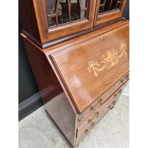 1062 - A small Edwardian mahogany and inlaid bureau bookcase, 66.5cm wide.