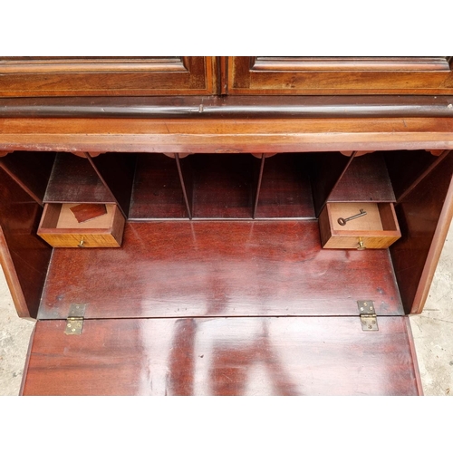 1062 - A small Edwardian mahogany and inlaid bureau bookcase, 66.5cm wide.