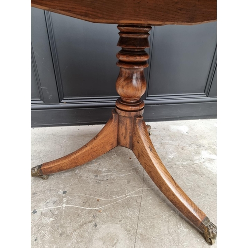 1063 - A 19th century oak tilt top tripod table, 81cm wide.