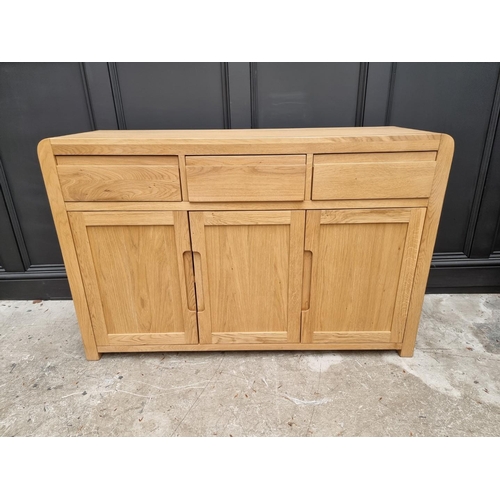 1068 - A contemporary pale oak side cabinet, 130cm wide.   