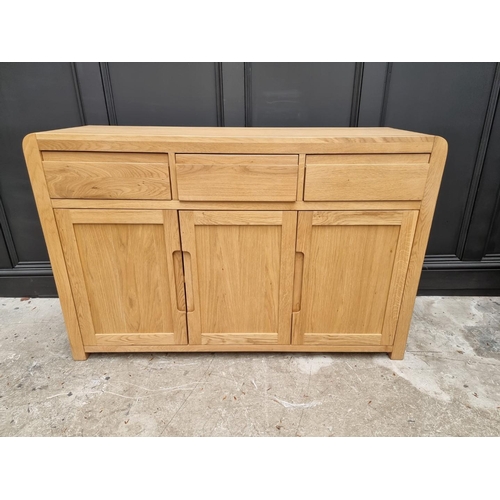 1068 - A contemporary pale oak side cabinet, 130cm wide.   