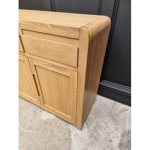 1068 - A contemporary pale oak side cabinet, 130cm wide.   