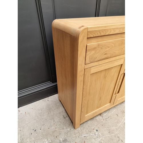 1068 - A contemporary pale oak side cabinet, 130cm wide.   