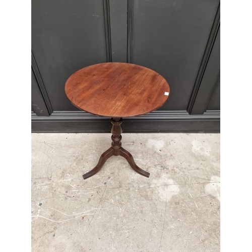 1069 - An early 19th century mahogany and oak circular tilt top tripod table, 48cm diameter. ... 