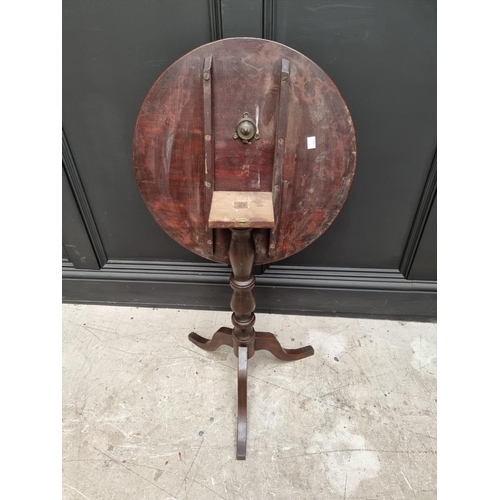 1069 - An early 19th century mahogany and oak circular tilt top tripod table, 48cm diameter. ... 