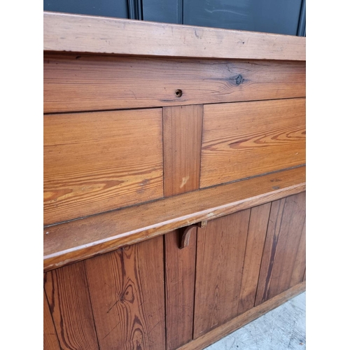 1074 - A Victorian pitch pine pew back, 162cm wide.