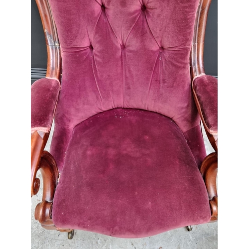 1075 - A Victorian mahogany and button upholstered open arm occasional chair. 