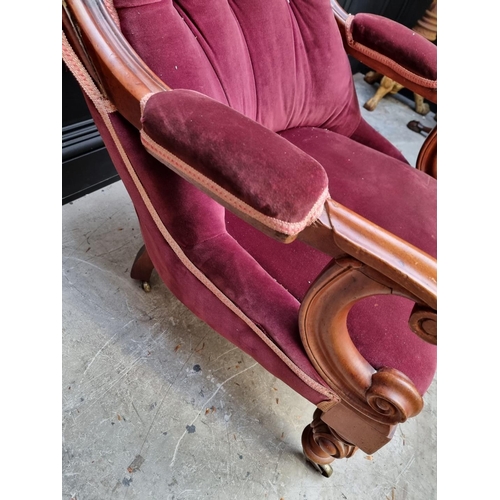 1075 - A Victorian mahogany and button upholstered open arm occasional chair. 