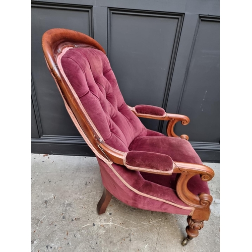 1075 - A Victorian mahogany and button upholstered open arm occasional chair. 