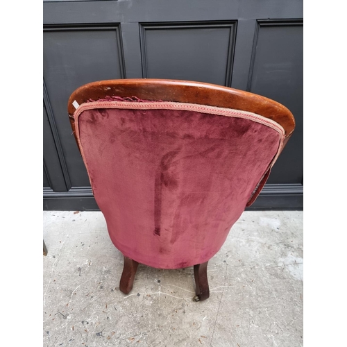 1075 - A Victorian mahogany and button upholstered open arm occasional chair. 