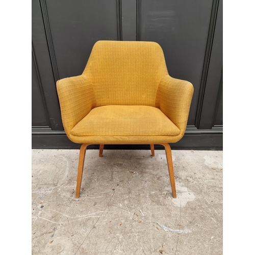 1077 - A mid-century upholstered armchair. 