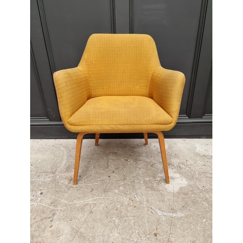 1077 - A mid-century upholstered armchair. 