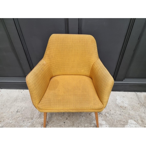 1077 - A mid-century upholstered armchair. 