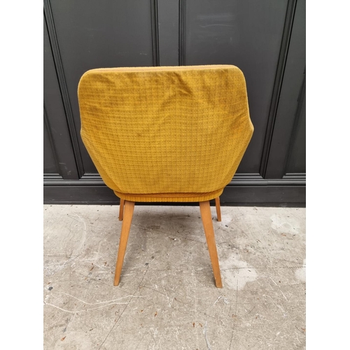 1077 - A mid-century upholstered armchair. 