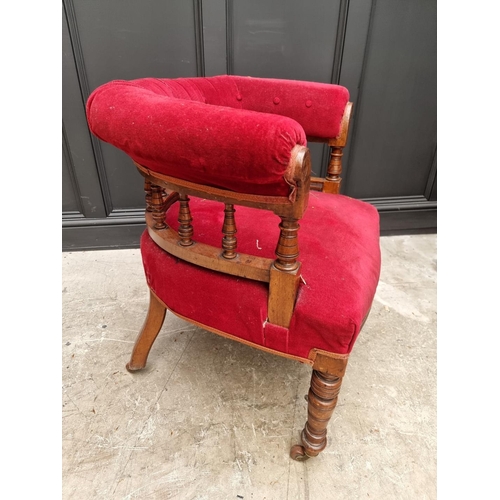 1080 - A late Victorian walnut and button upholstered desk chair.  