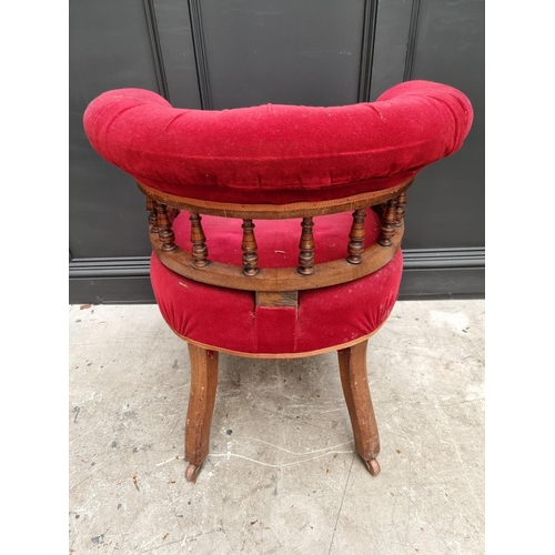 1080 - A late Victorian walnut and button upholstered desk chair.  